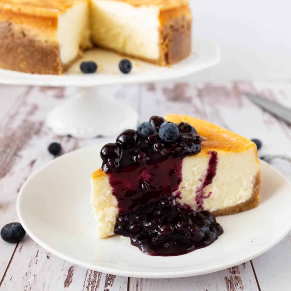 A slice of cheesecake with blueberry filling.