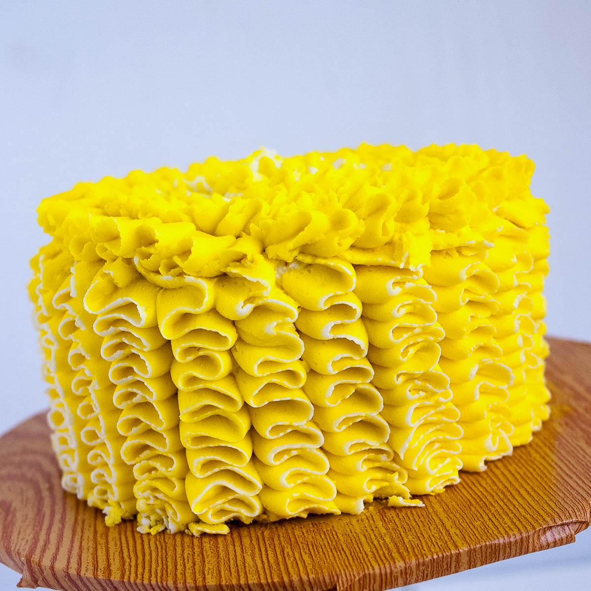 A frosted lemon cake on the table.
