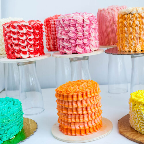 A collection of frosted cakes on the table.
