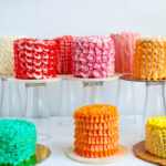 A collection of frosted cakes on the table.