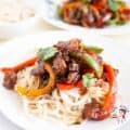 White plate with beef peppers stir fry