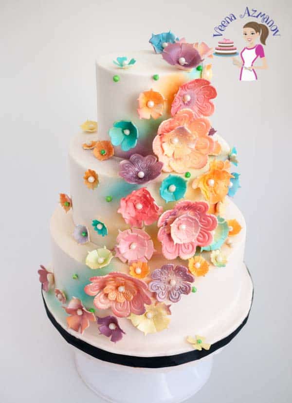 A wedding cake decorated with sugar flowers.