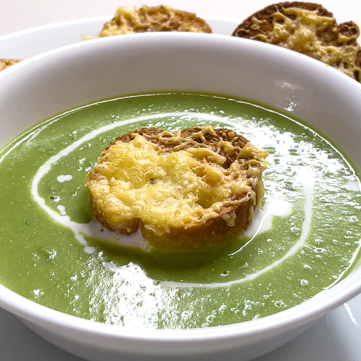 A bowl with fresh green pea soup.