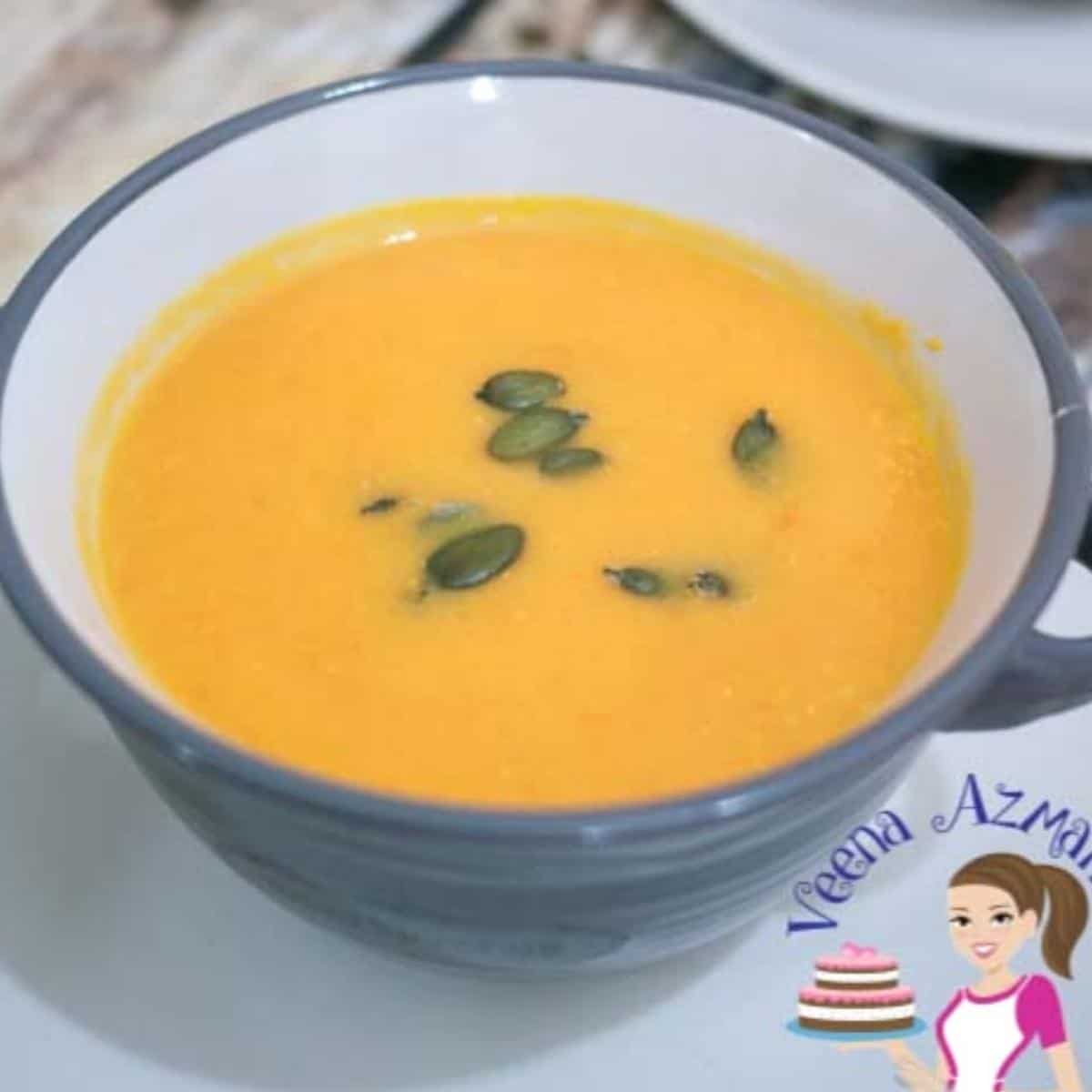 A bowl with soup made with pumpkins.