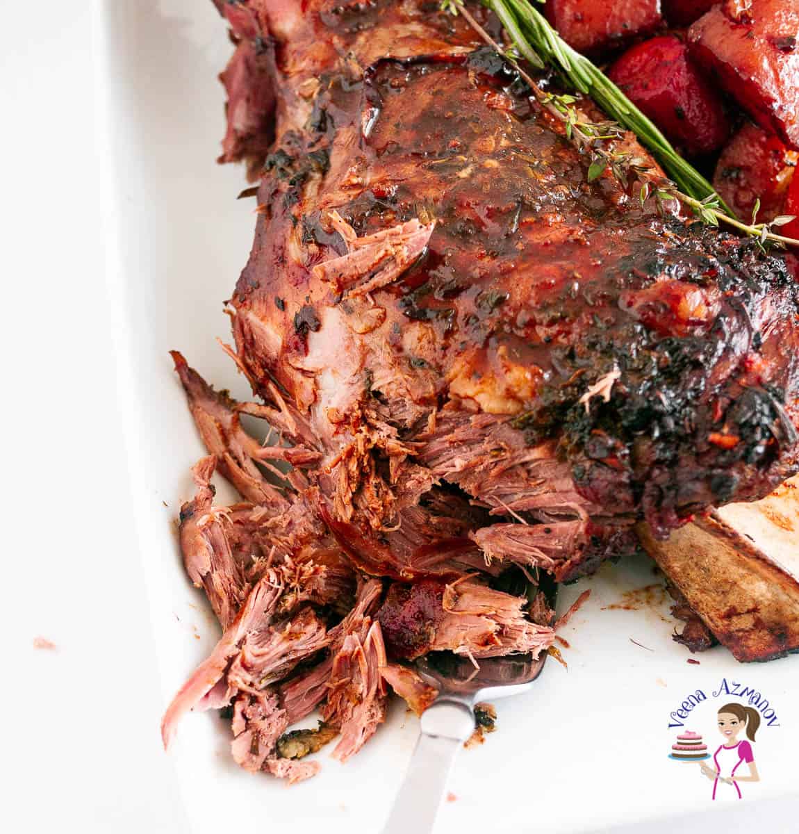 Roasted lamb shoulder on a tray.