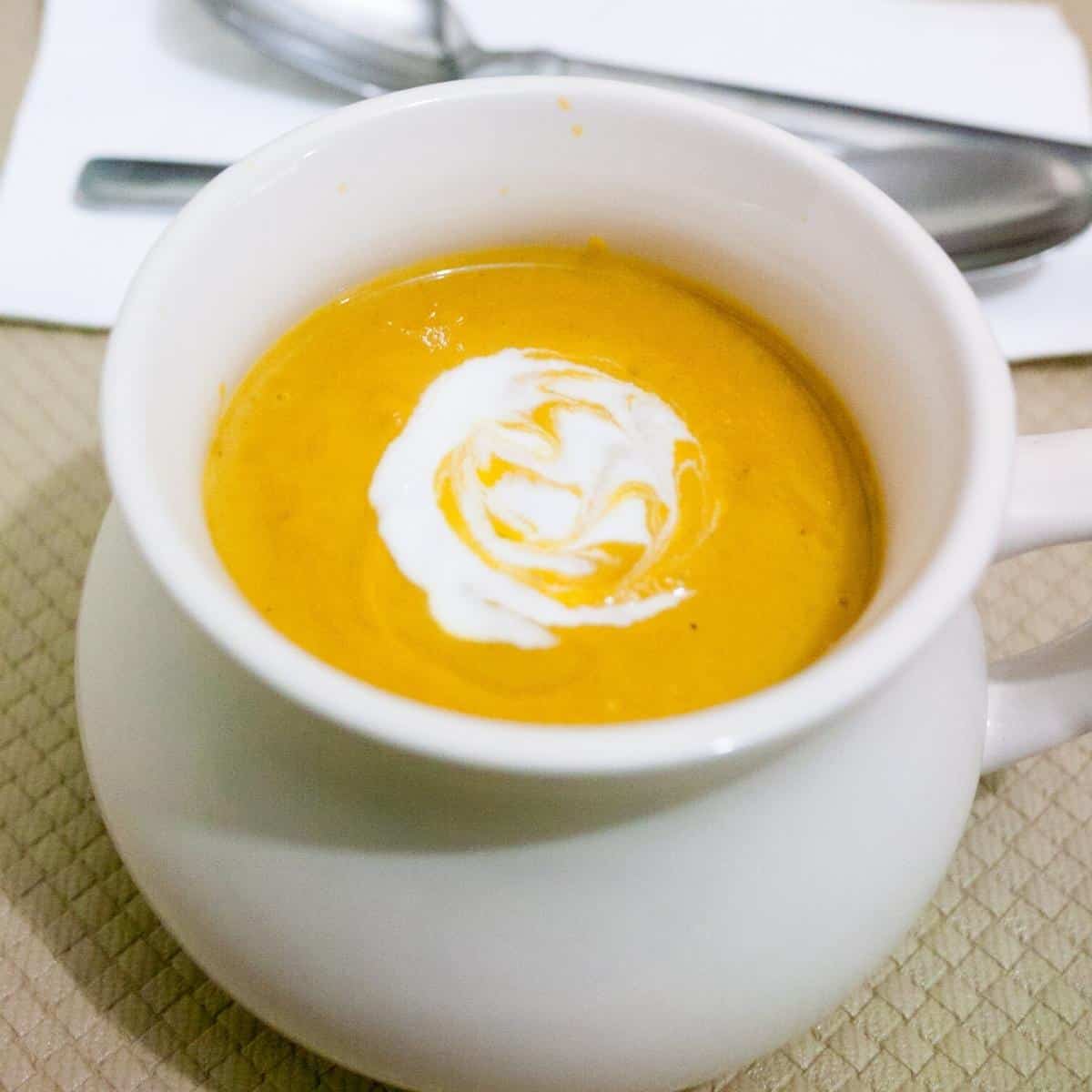 A bowl with pumpkin sweet potato soup.