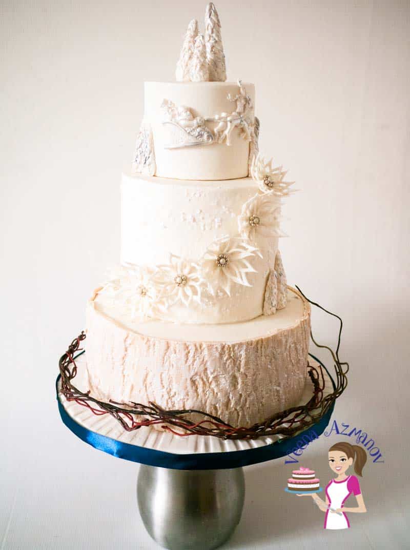 A wedding cake with white sugar flowers.