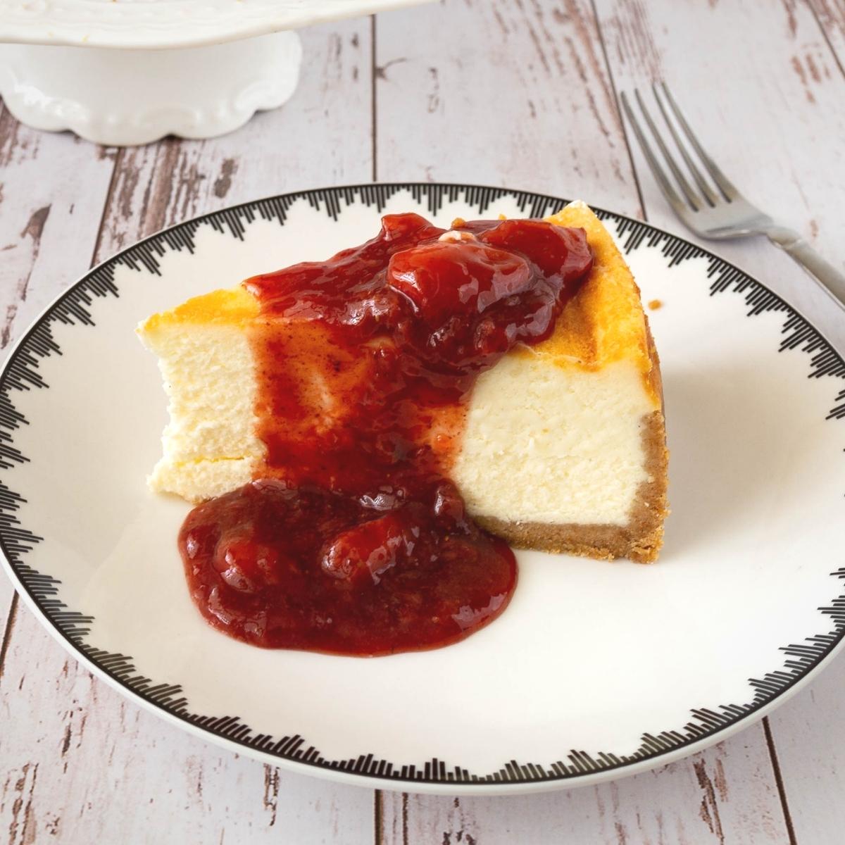 A slice of strawberry cheesecake on a plate.
