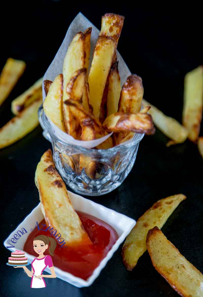 A glass filled with potato wedges.