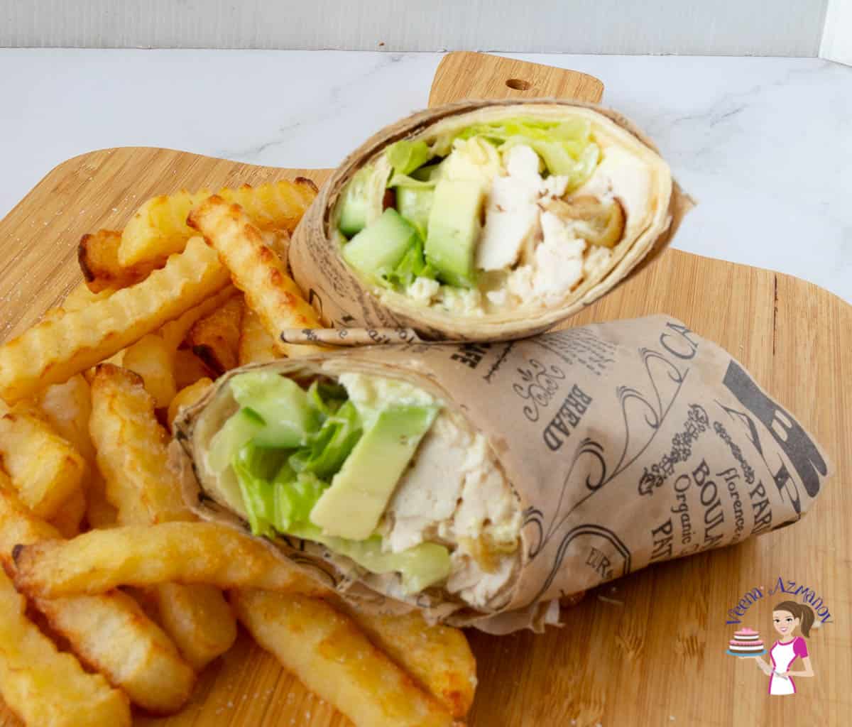 A chicken wrap on a wooden board