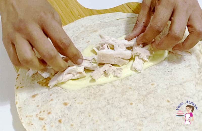 Add the shredded chicken on a the tortilla