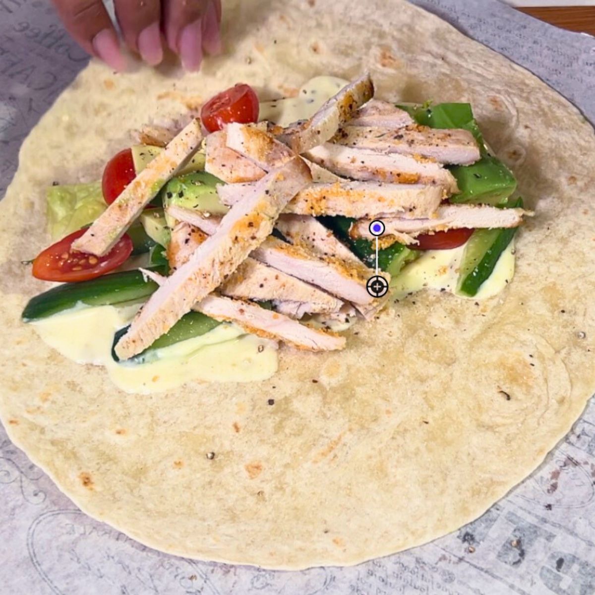Two chicken wraps on the table.