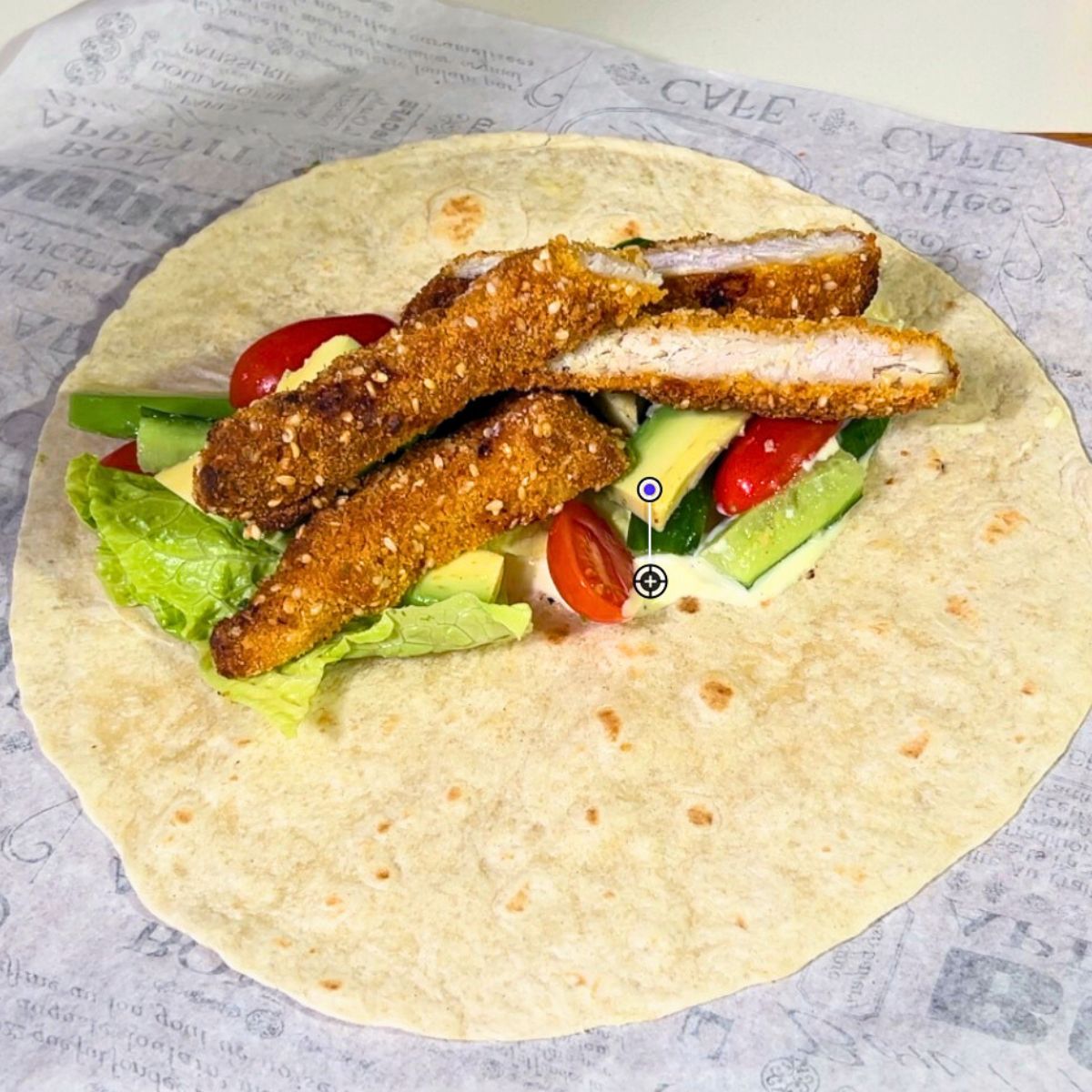 Two chicken wraps on the table.