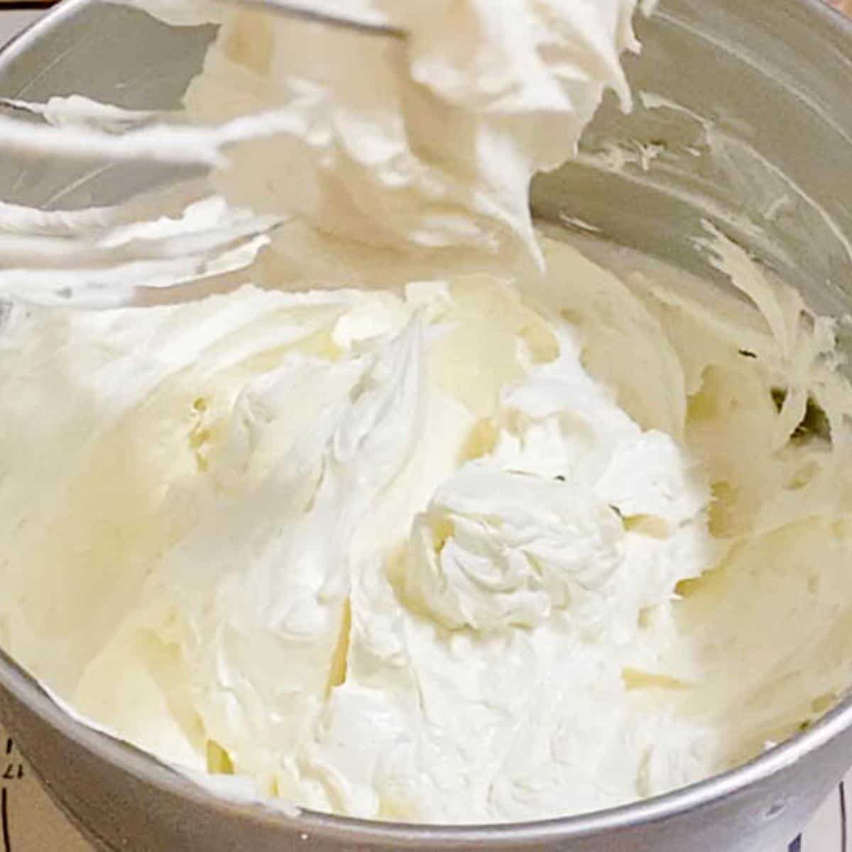 A mixer bowl with buttercream frosting.