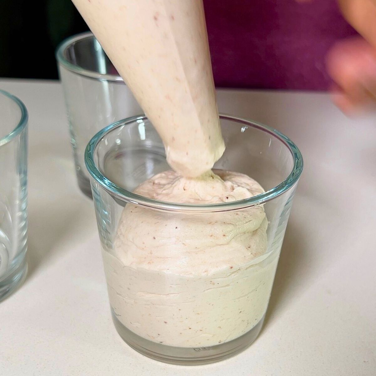Filling Chestnut mousse in dessert cups.