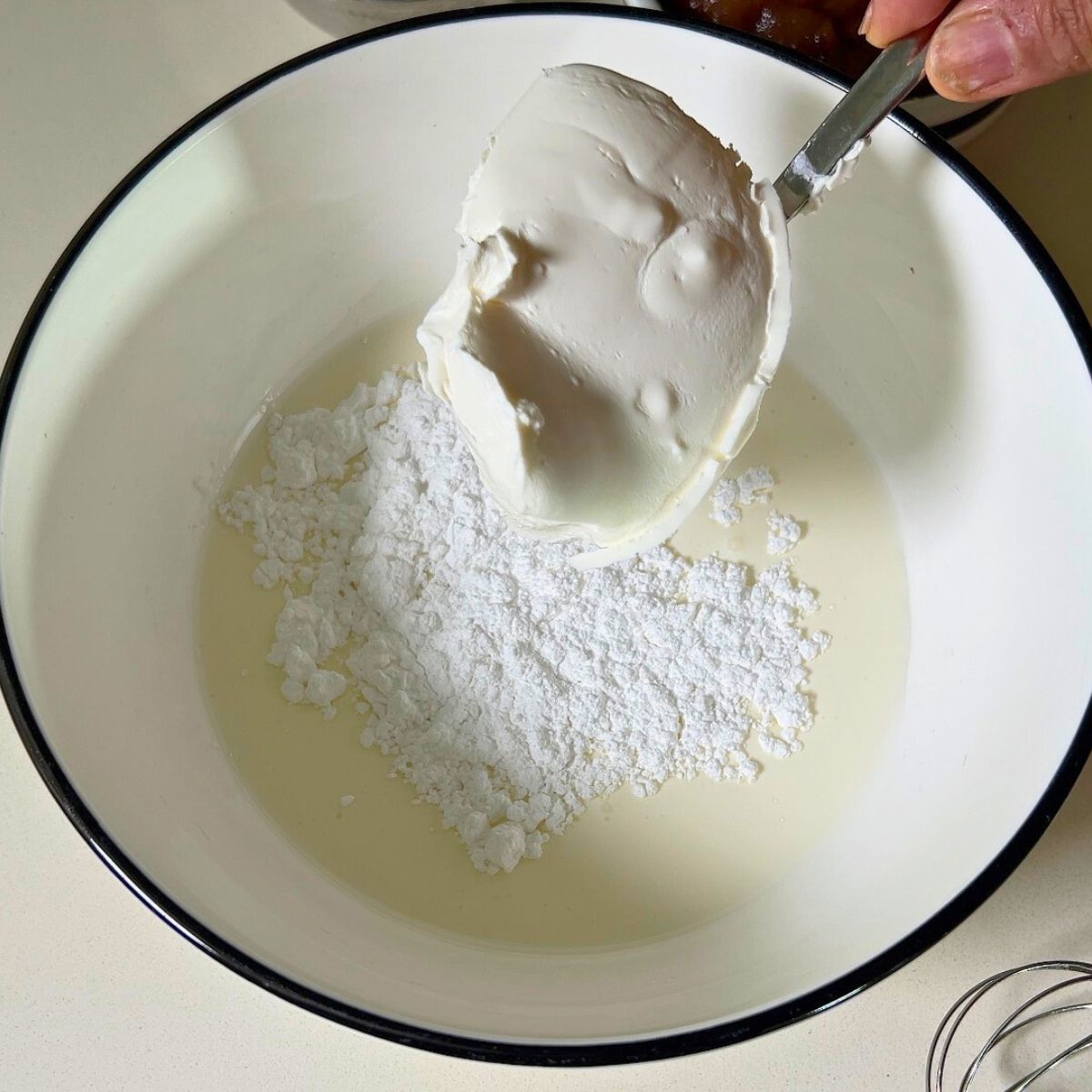 Whipping mousse in a white bowl.