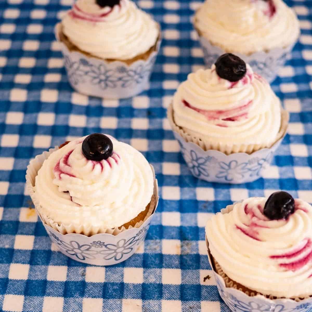Frosted cupcakes with blueberry fillling.