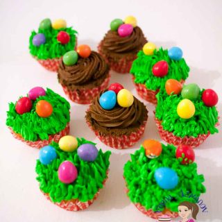 Cupcakes decorated with frosting and Easter eggs.