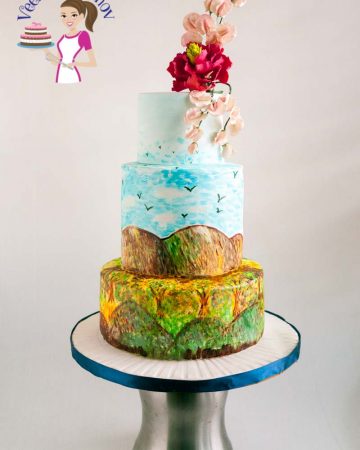 A hand painted cake with sugar flower on top.