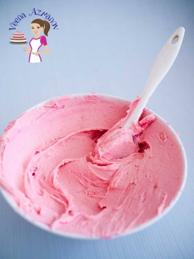 Pink buttercream in a bowl.