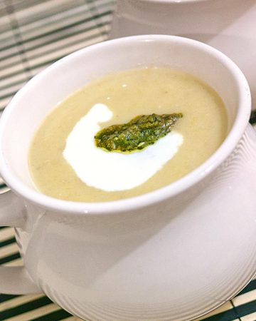 A white bowl with leek soup.