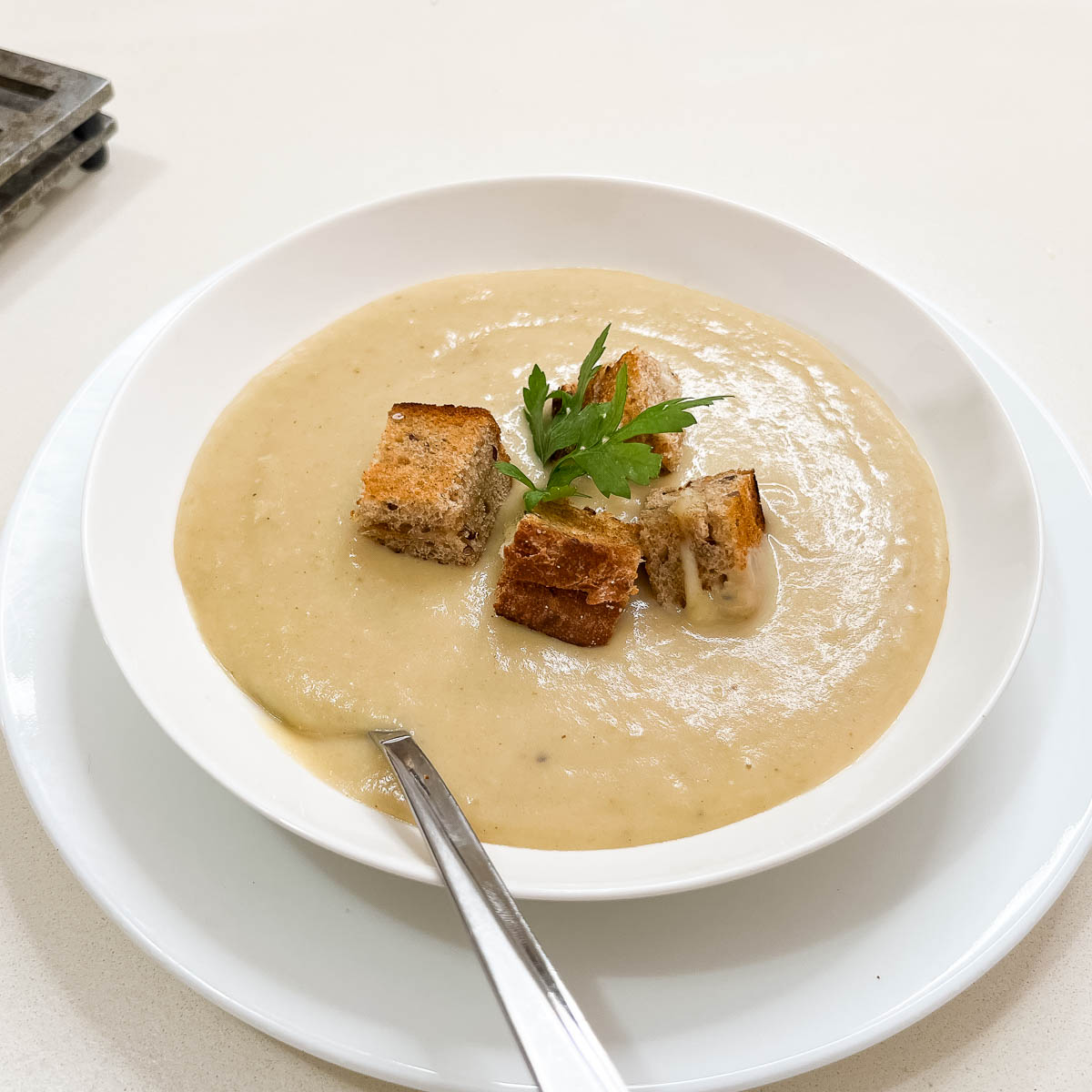 A bowl with potato and leek soup.