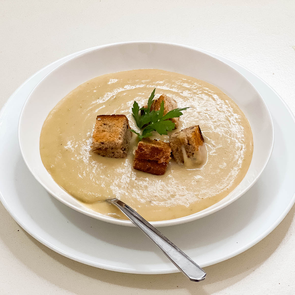 A bowl with potato and leek soup.