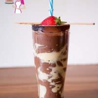 Strawberry chocolate smoothie in a tall glass.