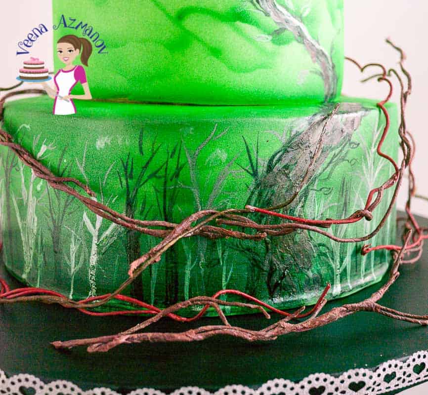 A close up of a cake decorated in a Jack and the Beanstalk theme.