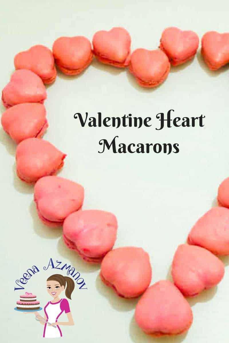 Heart-shaped macarons arranged in a heart shaped manner on a table.