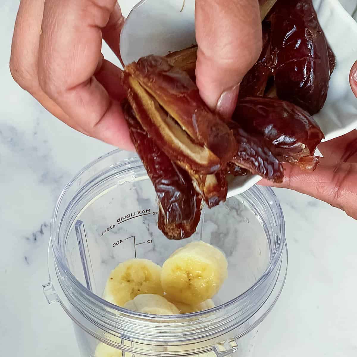 Adding pitted dates to the blender.