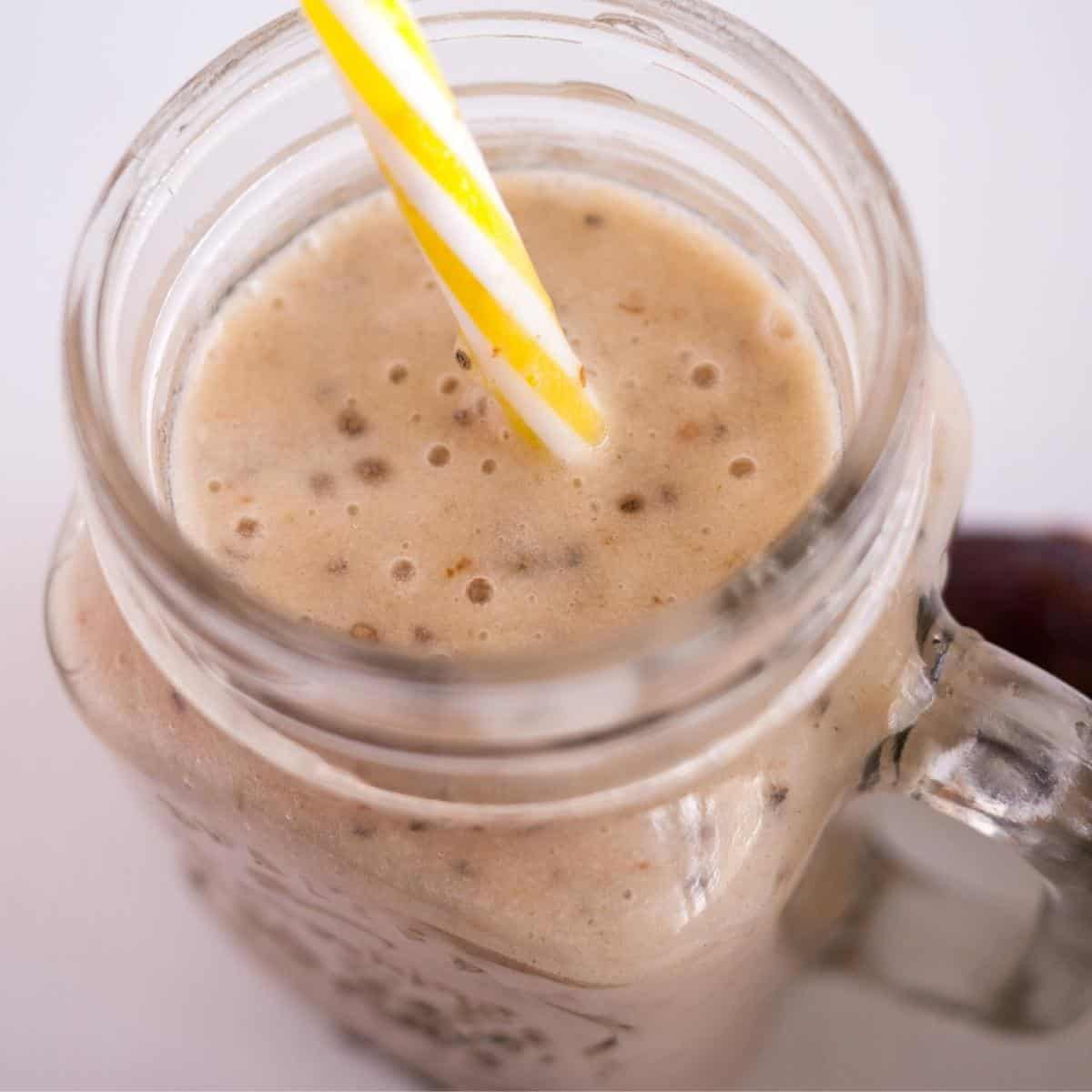 A glass jar with banana and dates smoothie