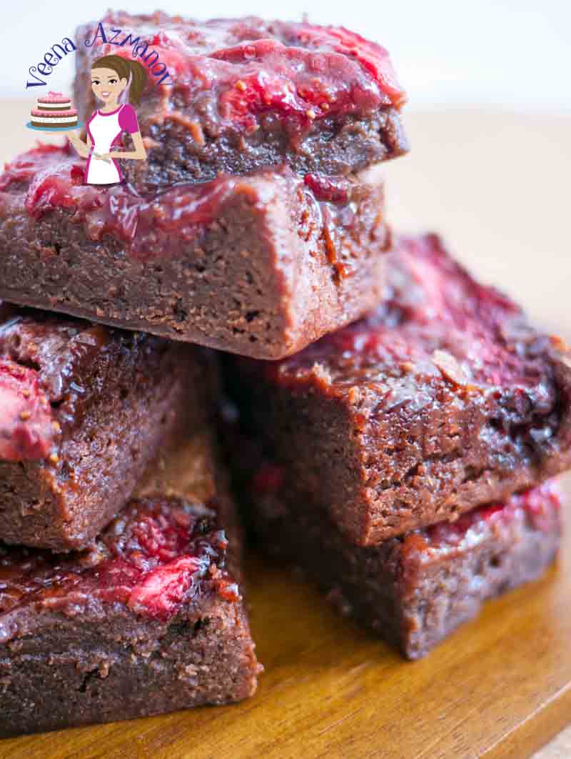 A stack of chocolate strawberry brownies on a table.