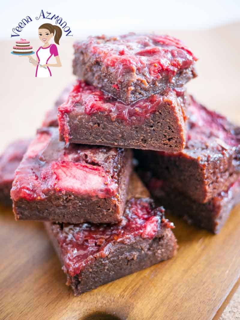 A stack of chocolate strawberry brownies on a table.