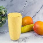 Banana Mango smoothie in a tall glass.
