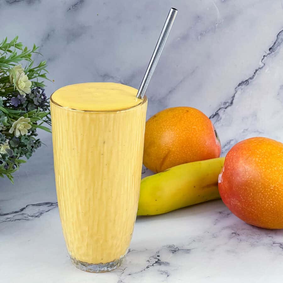 Banana Mango smoothie in a tall glass.