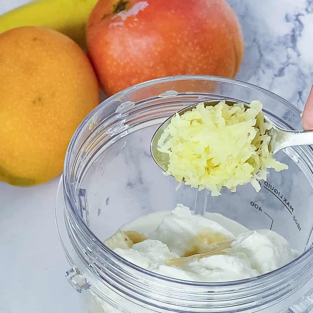 Adding ginger to the blender.