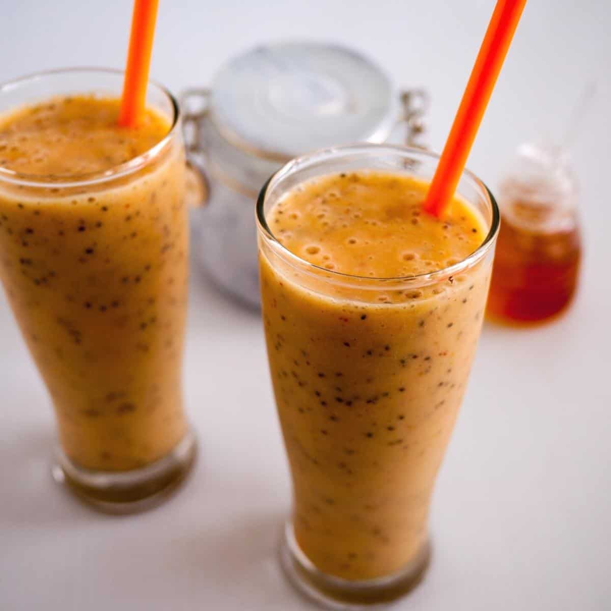 Two glasses with mango chai smoothies