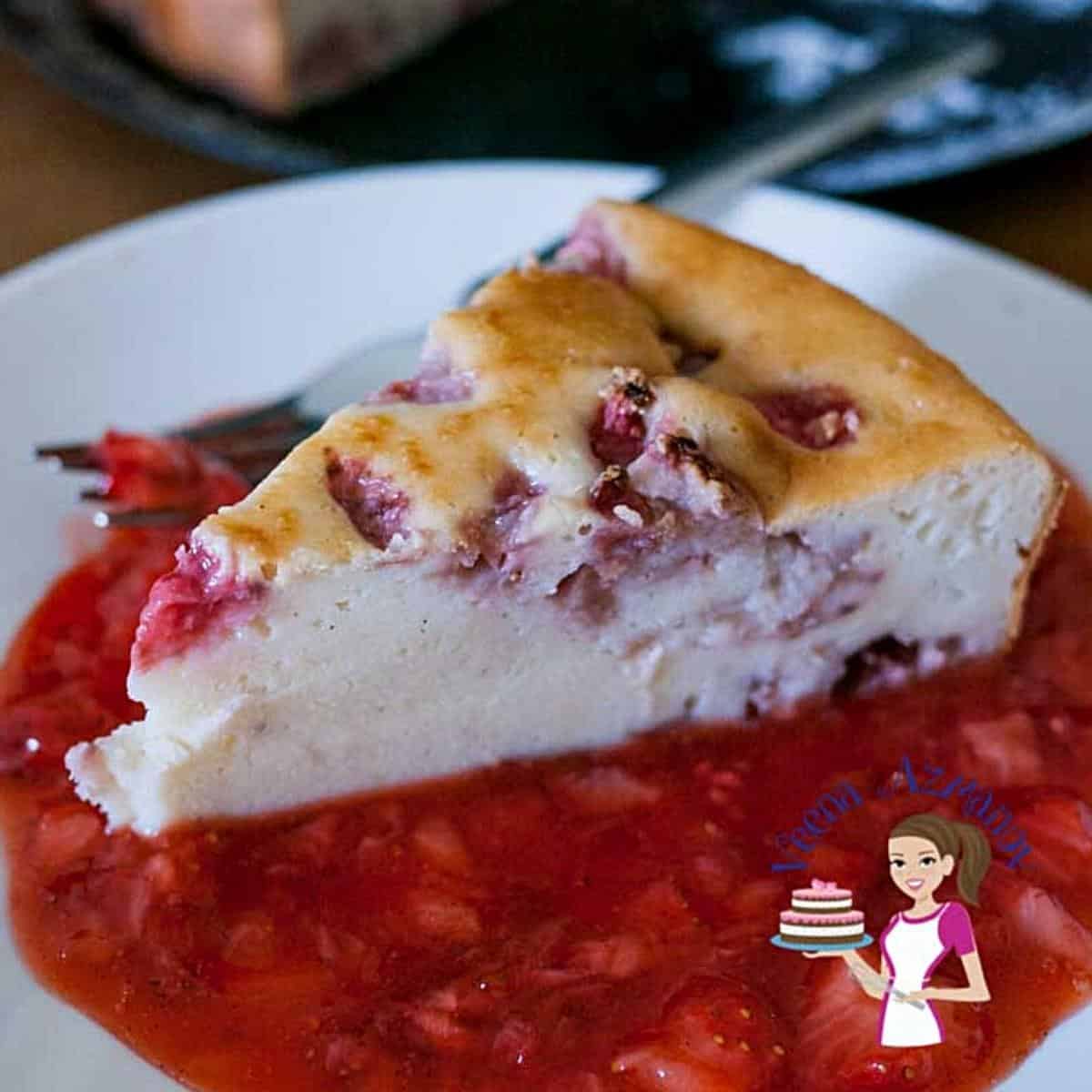 A slice of cheesecake on a plate with strawberry sauce.
