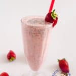 A glass of strawberry and banana milkshake.