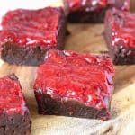 A few strawberry squares on the wooden board.