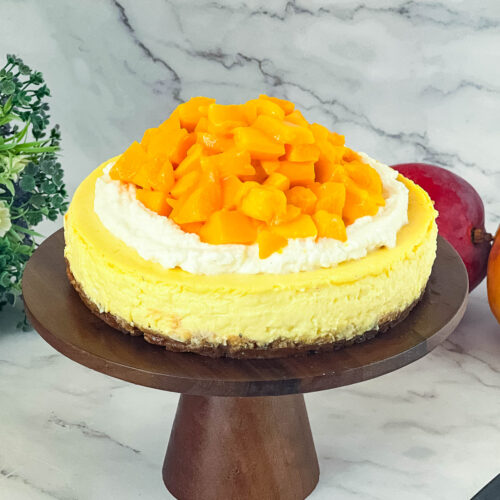Mango cheesecake on a stand.