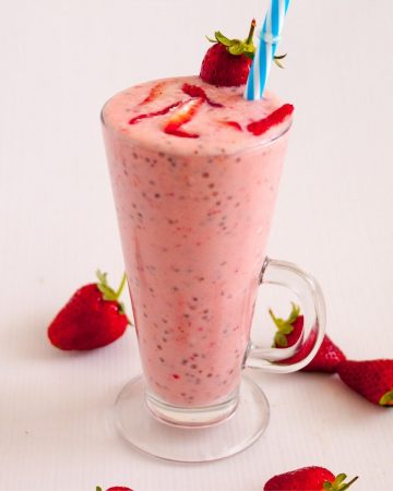 A berry smoothie in a tall glass.