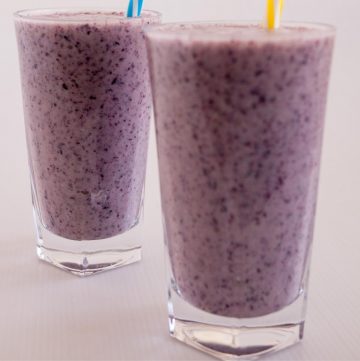 Two glasses of blueberry banana smoothie.