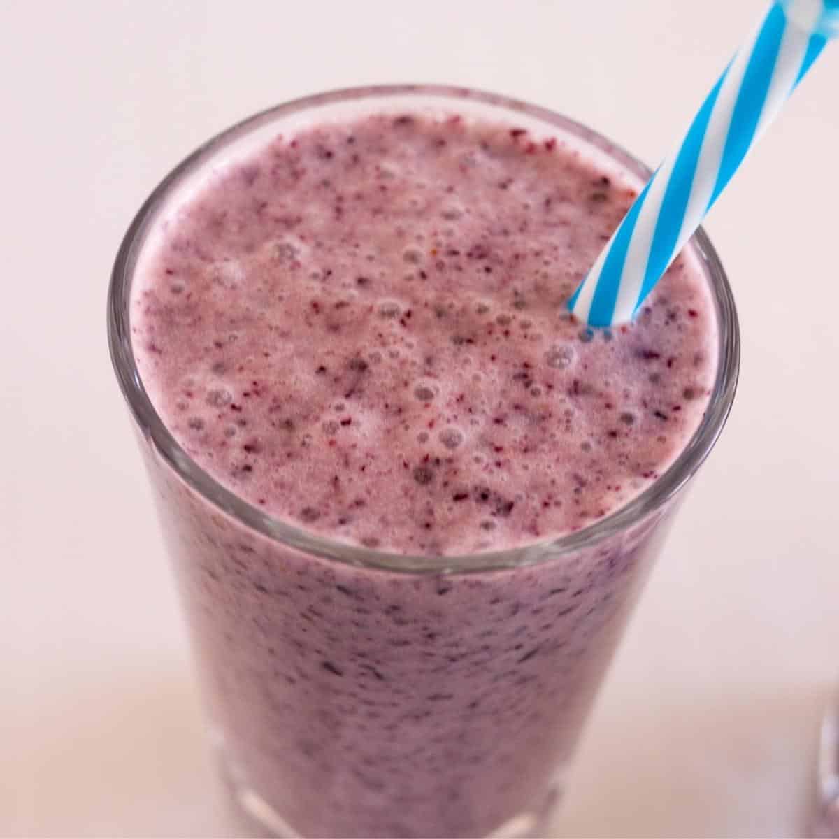 A glass of blueberry banana smoothie.