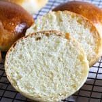 A sliced brioche bun in hand.