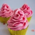 Three frosted cupcakes in pink champagne
