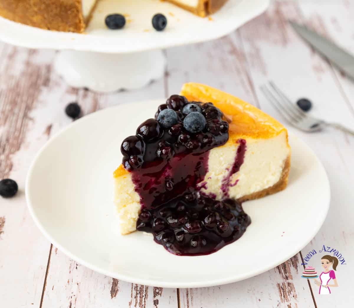 A slice of cheesecake with blueberry sauce.