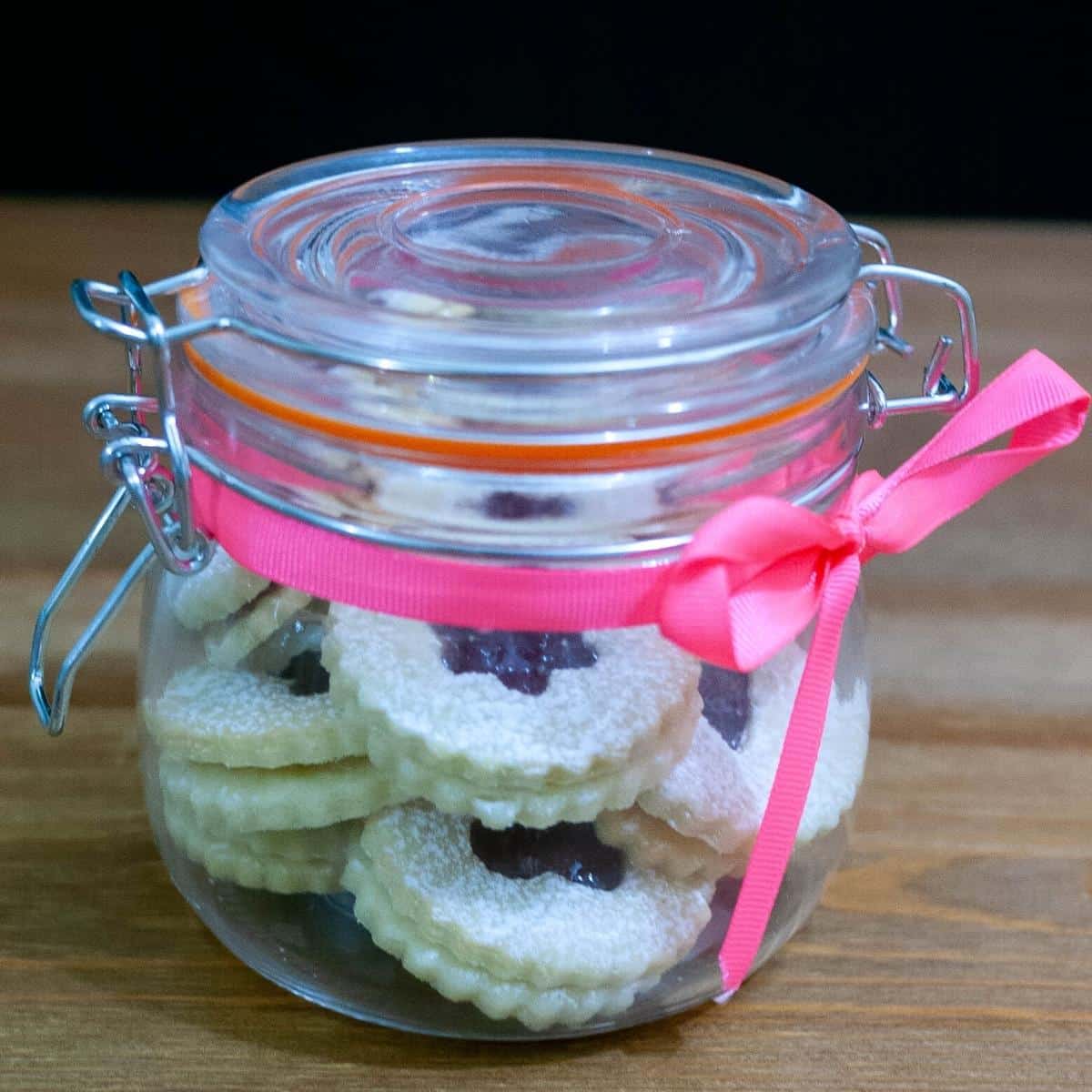 Linzer jam cookies in a holiday gift jar