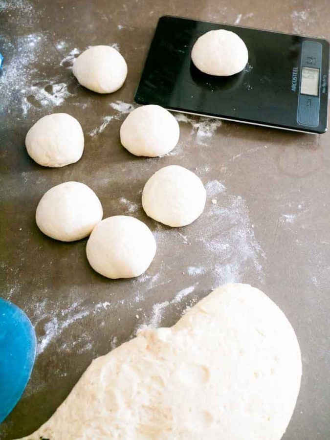 Making balls of dough for baking buns.
